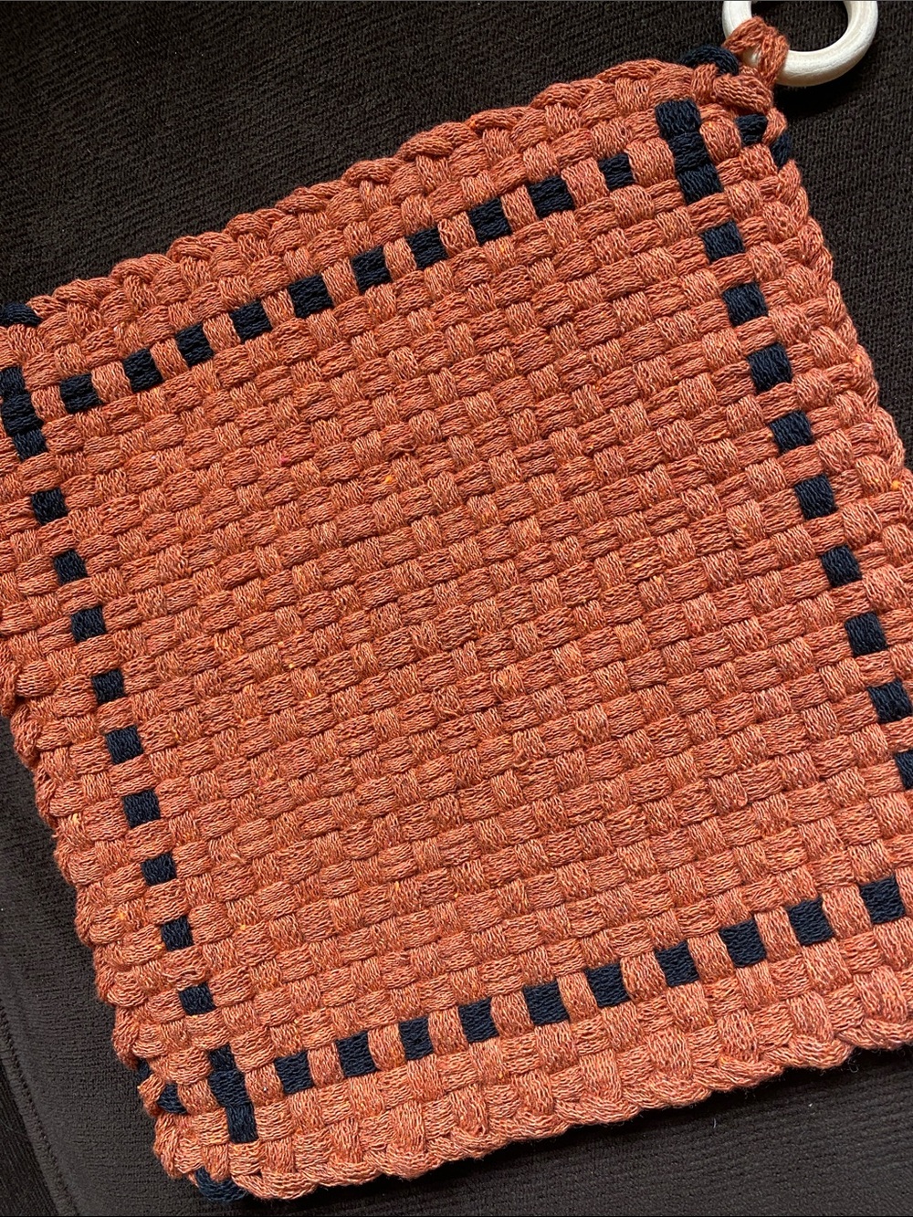 Handmade orange and black potholder.  8” square.  Cotton.